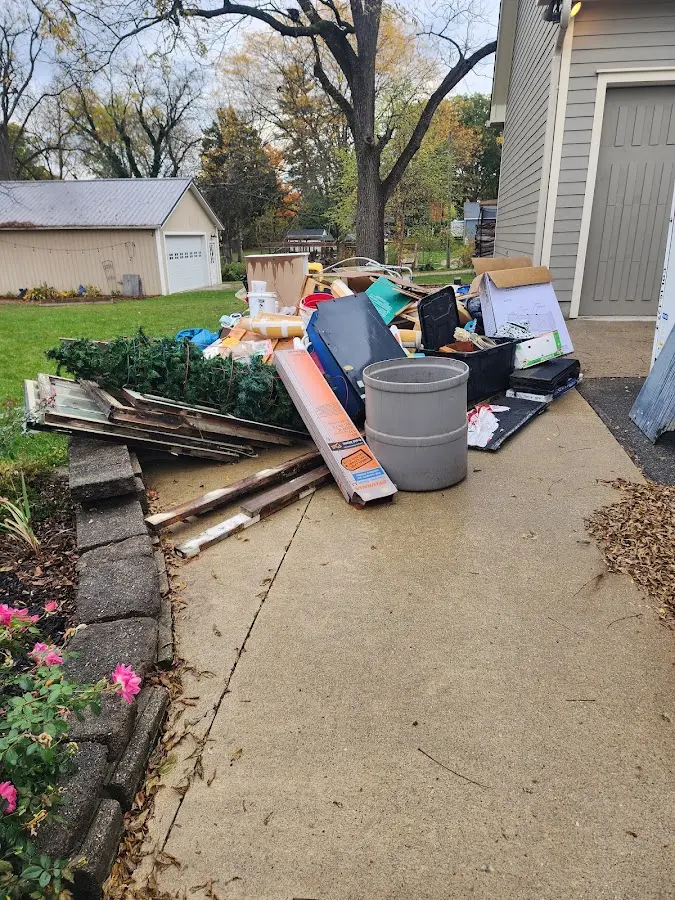 Dumpster being loaded with debris for Roofing Dumpster Rental in Blackhawk